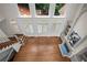 Open-concept living room with fireplace, built-in shelving, staircase, and lots of natural light at 8630 Moor Park Run, Duluth, GA 30097