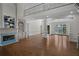 Open-concept living space showcasing a fireplace, balcony, hardwood floors and bright natural light at 8630 Moor Park Run, Duluth, GA 30097