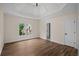 Spacious main bedroom with hardwood floors, large window, tray ceiling, and ensuite bathroom access at 8630 Moor Park Run, Duluth, GA 30097