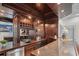 Wet bar in basement featuring custom wood cabinetry, granite countertops, and stainless steel appliances at 8630 Moor Park Run, Duluth, GA 30097
