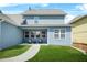 A cozy backyard with green grass and a covered patio featuring comfortable seating arrangements at 9990 Blackfriars Rd, Douglasville, GA 30135
