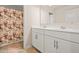 Bright bathroom featuring a dual sink vanity and a shower with a floral curtain at 9990 Blackfriars Rd, Douglasville, GA 30135