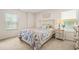 Cozy bedroom featuring a floral quilt, a nightstand, and a window for natural light at 9990 Blackfriars Rd, Douglasville, GA 30135