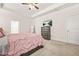 Spacious bedroom with a ceiling fan, TV, dresser, and a doorway leading to another room at 9990 Blackfriars Rd, Douglasville, GA 30135