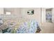 Bedroom with floral quilt, dresser, wall-mounted TV, and bathroom view, providing comfort and style at 9990 Blackfriars Rd, Douglasville, GA 30135