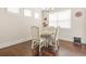 Bright breakfast nook area with hardwood floors, table set, and natural light from windows at 9990 Blackfriars Rd, Douglasville, GA 30135