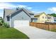 Charming two-story home with a two-car garage and well-maintained lawn and fence at 9990 Blackfriars Rd, Douglasville, GA 30135