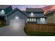 Charming two-story home with a two-car garage, well-maintained lawn and fence at twilight at 9990 Blackfriars Rd, Douglasville, GA 30135