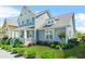 Charming two-story home featuring a welcoming front porch and lush landscaping at 9990 Blackfriars Rd, Douglasville, GA 30135
