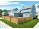 Charming two-story home with a two-car garage, well-maintained lawn and wooden fence at 9990 Blackfriars Rd, Douglasville, GA 30135