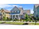 Charming two-story home featuring a welcoming front porch, lush lawn, and mature landscaping at 9990 Blackfriars Rd, Douglasville, GA 30135