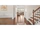 Elegant foyer with hardwood floors, detailed trim, and staircase leading to the upper level at 9990 Blackfriars Rd, Douglasville, GA 30135
