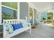 Inviting front porch featuring a comfortable bench, rocking chairs, and stylish decor at 9990 Blackfriars Rd, Douglasville, GA 30135