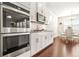 Kitchen features stainless steel appliances, white subway tile backsplash, and white cabinets at 9990 Blackfriars Rd, Douglasville, GA 30135