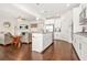 Open-concept kitchen flowing into the living room featuring white cabinets, granite counters, and stainless appliances at 9990 Blackfriars Rd, Douglasville, GA 30135
