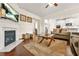 Open-concept living room with hardwood floors, fireplace, and view into the modern kitchen at 9990 Blackfriars Rd, Douglasville, GA 30135