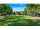 Lush community park lined with mature trees and walking paths, offering a serene outdoor space at 9990 Blackfriars Rd, Douglasville, GA 30135