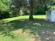 Expansive backyard with mature trees, providing shade and a tranquil atmosphere at 106 E Wade St, Oxford, GA 30054