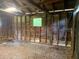 Unfinished basement showing wood studs, partial walls, and small window at 106 E Wade St, Oxford, GA 30054