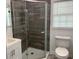 Cozy bathroom featuring a tile shower, vanity, and toilet, combining functionality with modern style at 106 E Wade St, Oxford, GA 30054