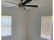 Inviting bedroom featuring a modern ceiling fan and two bright windows, offering a simple design at 106 E Wade St, Oxford, GA 30054