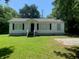 Charming one-story house with a well-maintained front lawn and classic architectural details at 106 E Wade St, Oxford, GA 30054
