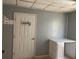 Laundry room featuring wall rack, closet, counter, and exterior door, combining functionality with modern style at 106 E Wade St, Oxford, GA 30054