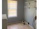 Laundry room with shelving, washer hook-ups, and a bright window, combining functionality with simplicity at 106 E Wade St, Oxford, GA 30054