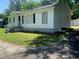 Side exterior view of a single-story home with traditional architectural features and manicured lawn at 106 E Wade St, Oxford, GA 30054