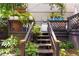 Back yard stairs leading up to small deck surrounded by lots of foliage at 1180 Branch Water Ct, Dunwoody, GA 30338
