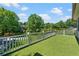 Large outdoor balcony with artificial turf, a white railing, and views of surrounding greenery at 1180 Branch Water Ct, Dunwoody, GA 30338