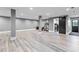 Spacious basement with wood-look floors, exercise area, and walk-out door at 1180 Branch Water Ct, Dunwoody, GA 30338