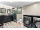 Elegant bathroom with glass-enclosed shower, double vanity, and washer/dryer at 1180 Branch Water Ct, Dunwoody, GA 30338