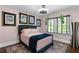 Inviting bedroom featuring framed art, a hanging plant, and a comfortable bed with a decorative throw at 1180 Branch Water Ct, Dunwoody, GA 30338