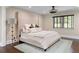 Bright bedroom featuring a neutral palette, a large upholstered headboard, and hardwood floors at 1180 Branch Water Ct, Dunwoody, GA 30338