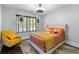 Cozy bedroom with a comfortable bed, hanging plants by the window, and a colorful rug at 1180 Branch Water Ct, Dunwoody, GA 30338