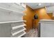 Custom walk-in closet with plenty of shelving, laundry machine, and a hair dryer on a stand at 1180 Branch Water Ct, Dunwoody, GA 30338