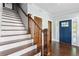 Bright foyer featuring hardwood floors, wooden stairs, and a stylish front door at 1180 Branch Water Ct, Dunwoody, GA 30338