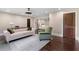Home office featuring a desk, couch, hardwood floors, and an open doorway leading to a bedroom at 1180 Branch Water Ct, Dunwoody, GA 30338