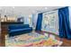 Open-concept living room with hardwood floors, a colorful rug, and patio doors leading to the backyard at 1180 Branch Water Ct, Dunwoody, GA 30338