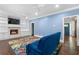 Bright living room features a fireplace, built-in shelving, a colorful rug, and a comfortable blue sofa at 1180 Branch Water Ct, Dunwoody, GA 30338