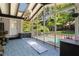Bright screened porch with skylights overlooking the pool and green landscaping at 1180 Branch Water Ct, Dunwoody, GA 30338
