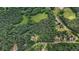 A high angle view of the property surrounded by lush greenery and trees at 2026 Mcdaniel Mill Sw Rd, Conyers, GA 30094