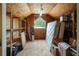 View of the unfinished attic space featuring wood floors, shelving, natural light from a window, and storage for belongings at 2026 Mcdaniel Mill Sw Rd, Conyers, GA 30094