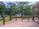 View from back deck overlooking large backyard with wooden railing and mature trees providing privacy at 2026 Mcdaniel Mill Sw Rd, Conyers, GA 30094