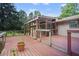 Exterior view of the back deck and screened-in porch, showing wooden flooring and backyard view at 2026 Mcdaniel Mill Sw Rd, Conyers, GA 30094