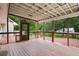 A view from the back porch featuring a screened-in area, wooden flooring and railing, and the backyard at 2026 Mcdaniel Mill Sw Rd, Conyers, GA 30094