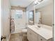 Bathroom featuring a tub with shower, a sink, a large mirror, and neutral tones at 2026 Mcdaniel Mill Sw Rd, Conyers, GA 30094