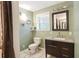 Bathroom with tile floors, toilet, and modern vanity with storage, plus a window at 2026 Mcdaniel Mill Sw Rd, Conyers, GA 30094
