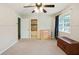 Carpeted bedroom featuring 2 dressers, a window and a doorway to an en-suite bathroom at 2026 Mcdaniel Mill Sw Rd, Conyers, GA 30094